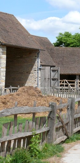 16th century farm buildings, with a pile of hay.