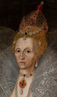 An elegant but weary looking woman in silvery white, wearing magnificent jewels,